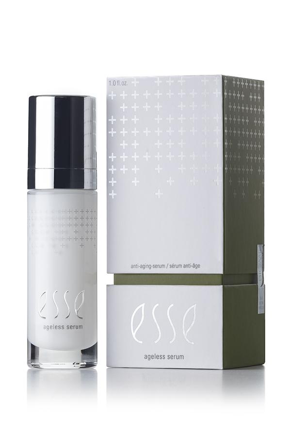 A minimalist-designed product photo featuring a white and silver bottle of Esse Ageless Serum next to its corresponding packaging box. The box is primarily white with plus sign graphics and a green section at the bottom. The text reads "anti-aging serum" and "Esse Ageless Serum.