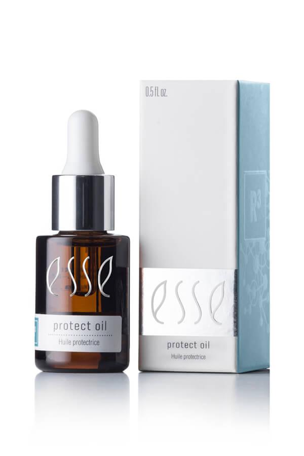 A 0.5 fl oz brown glass bottle with a dropper cap, labeled "Esse Protect Oil," is positioned beside its matching rectangular box. The minimalist design on the box incorporates white and light blue colors with text displaying the same product name.